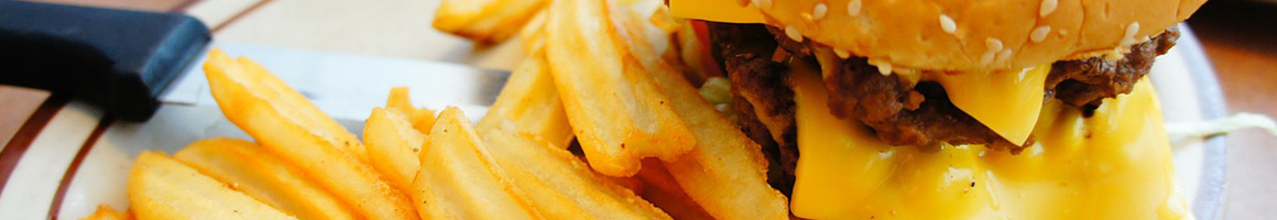 Eating American (Traditional) Burger Seafood at Ocean Bleu Seafoods at Gino's restaurant in Newport, OR.